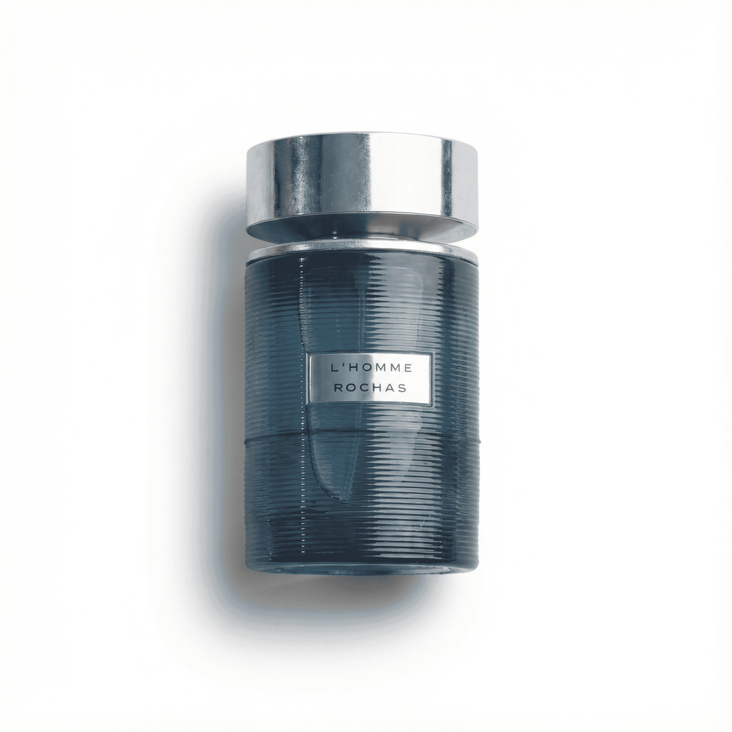 Luxurious men's fragrance bottle L'Homme Rochas, elegant design, modern scent, perfect for refined style.