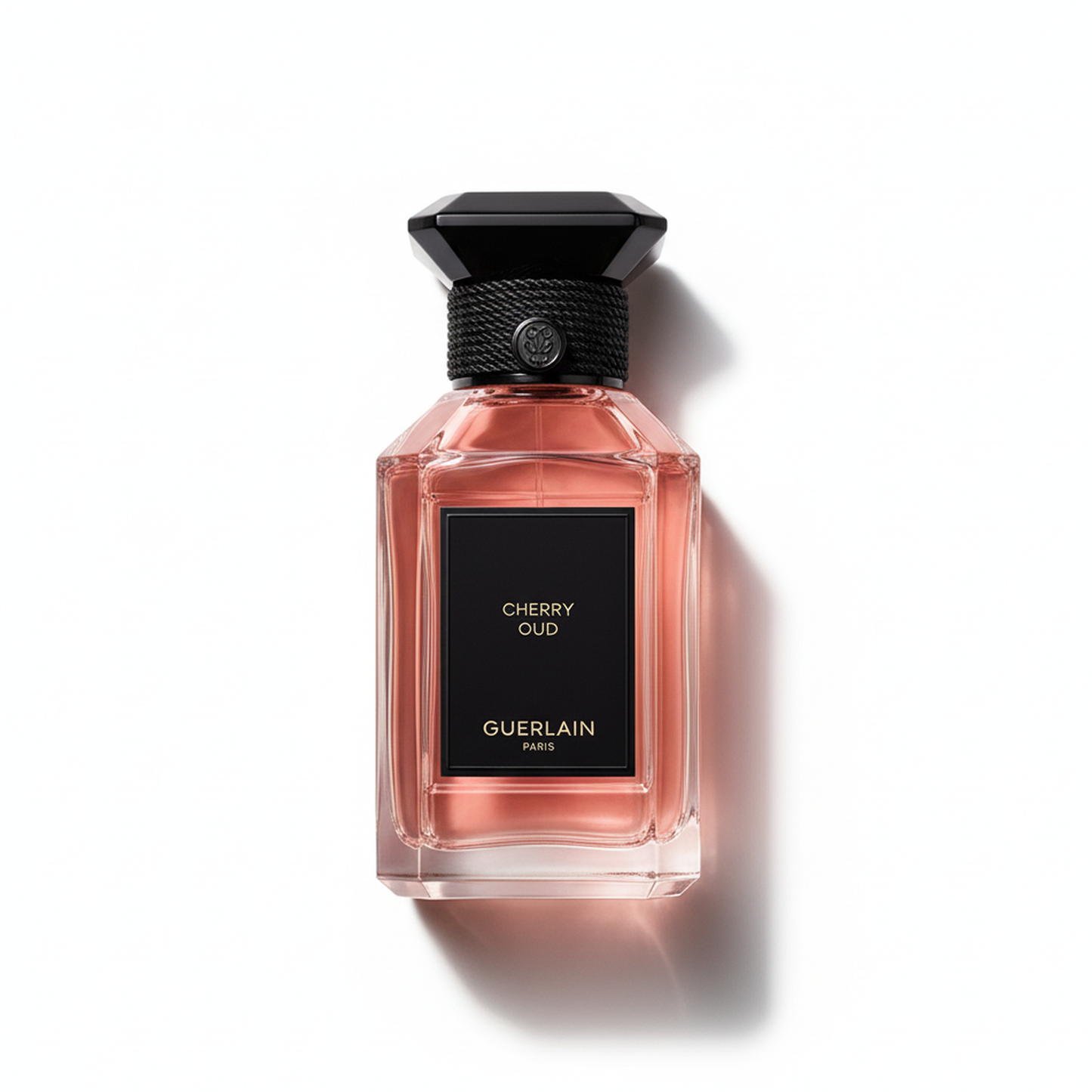 Bottle of Guerlain Cherry Oud EDP fragrance on a white background with soft shadow
