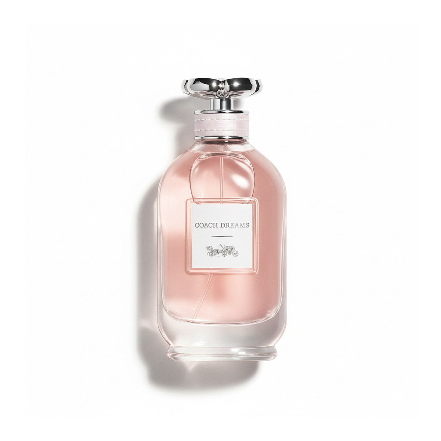 Bottle of Coach Dreams EDP fragrance on a white background with soft shadow