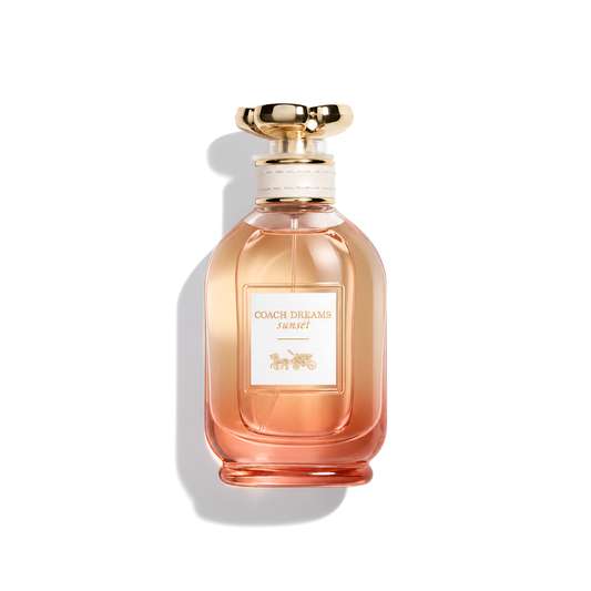 Bottle of Coach Dreams Sunset EDP fragrance on a white background with soft shadow