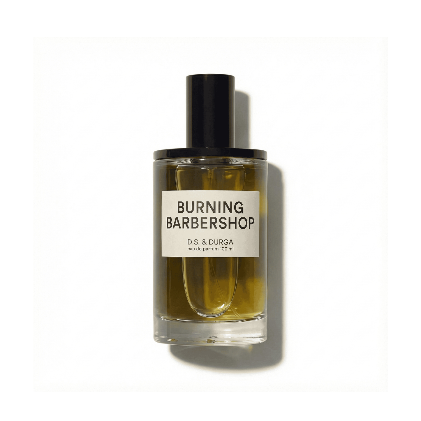 Bottle of D.S.&Durga Burning Barbershop EDP fragrance on a white background with soft shadow