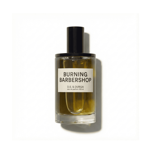 Bottle of D.S.&Durga Burning Barbershop EDP fragrance on a white background with soft shadow