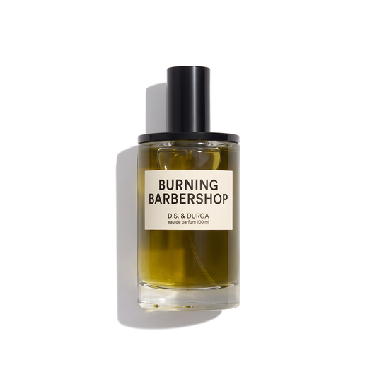 Bottle of D.S.&Durga Burning Barbershop EDP fragrance on a white background with soft shadow