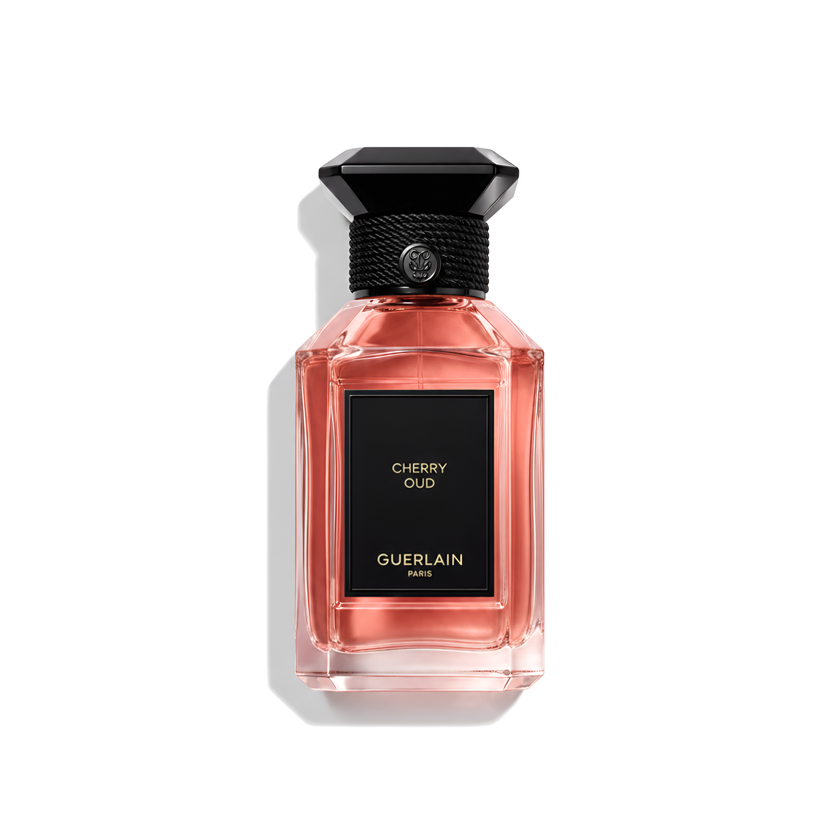 Bottle of Guerlain Cherry Oud EDP fragrance on a white background with soft shadow