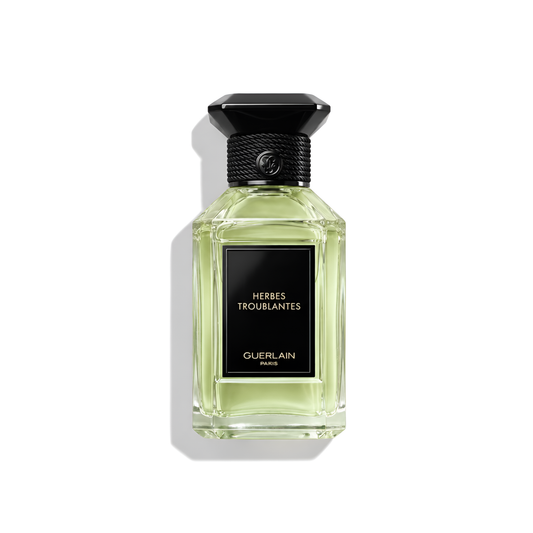 Bottle of Guerlain Herbes Troublantes EDP fragrance on a white background with soft shadow