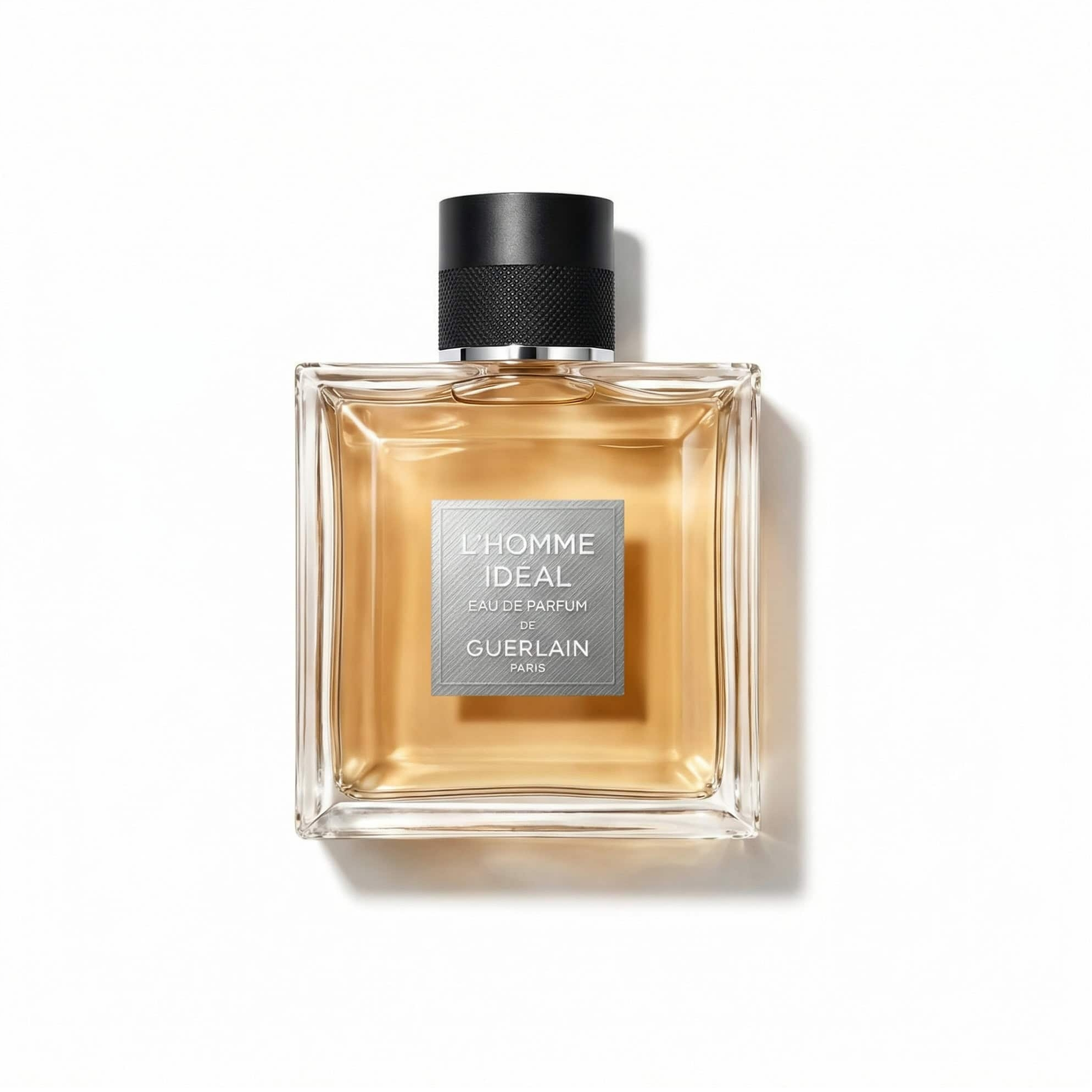 Bottle of Guerlain L’Homme Ideal EDP fragrance on a white background with soft shadow