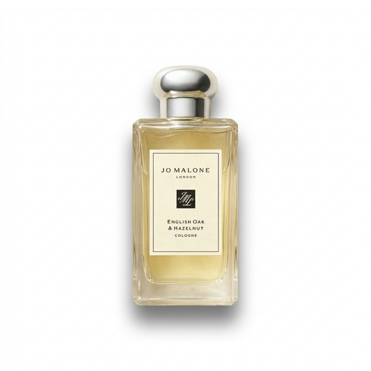 Bottle of Jo Malone English Oak & Hazelnut Cologne fragrance on a white background with soft shadow