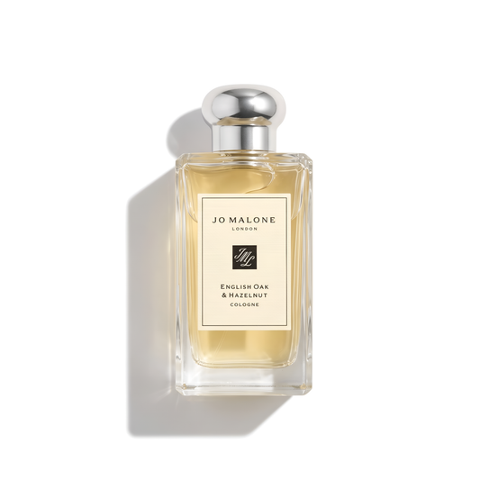 Bottle of Jo Malone English Oak & Hazelnut Cologne fragrance on a white background with soft shadow
