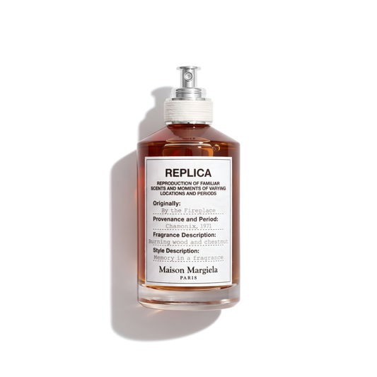 Bottle of Margiela By the Fireplace EDT fragrance on a white background with soft shadow