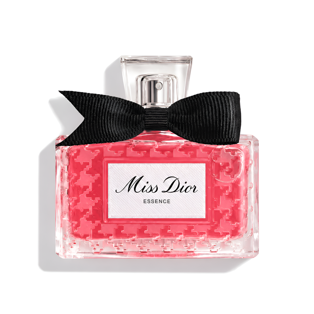 Bottle of Miss Dior Essence Extrait fragrance on a white background with soft shadow