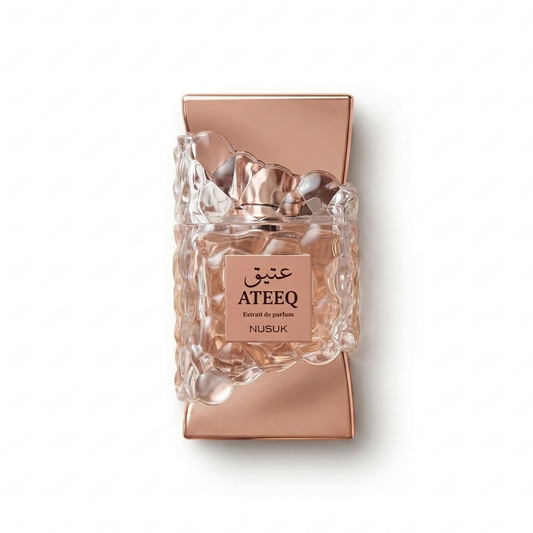 Bottle of Nusuk Ateeq Extrait fragrance on a white background with soft shadow