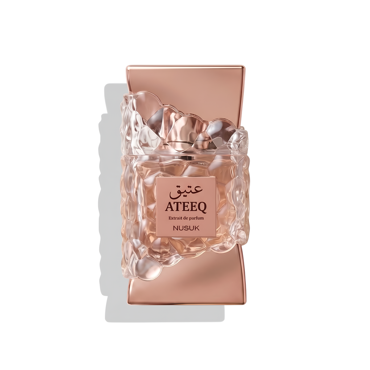 Bottle of Nusuk Ateeq Extrait fragrance on a white background with soft shadow
