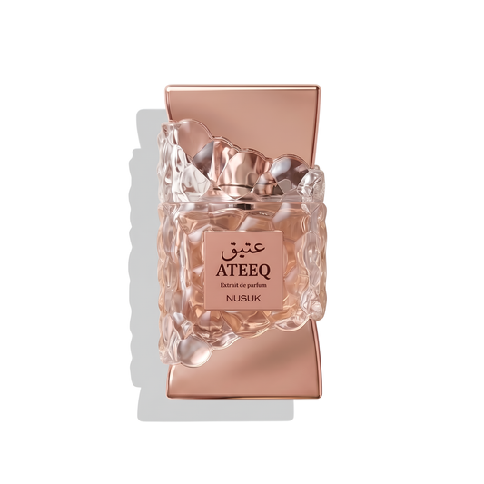 Bottle of Nusuk Ateeq Extrait fragrance on a white background with soft shadow