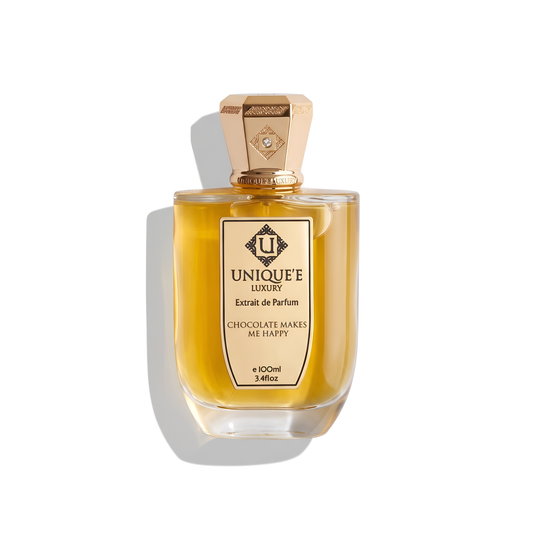 Bottle of Unique'E Luxury Chocolate Makes Me Happy Extrait fragrance on a white background with soft shadow