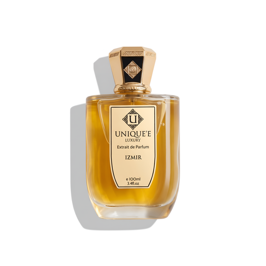 Bottle of Unique'E Luxury Izmir Extrait fragrance on a white background with soft shadow