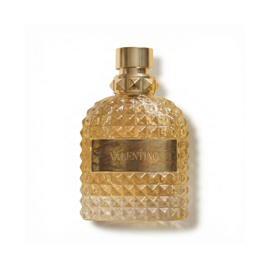 Bottle of Valentino Uomo Born in Roma The Gold EDT fragrance on a white background with soft shadow