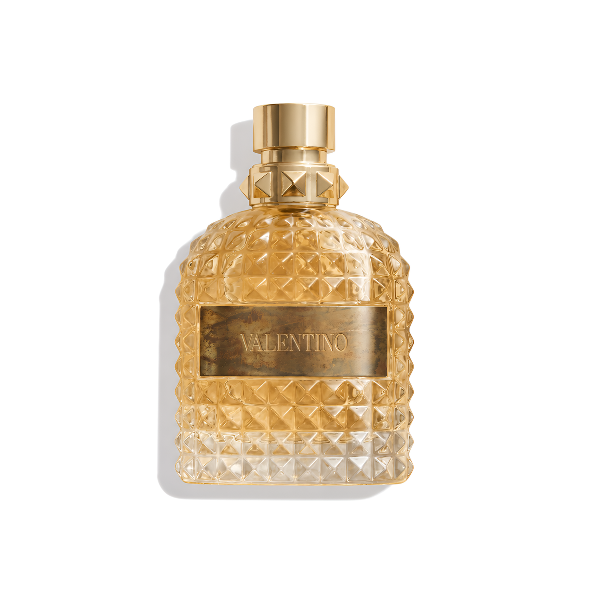 Bottle of Valentino Uomo Born in Roma The Gold EDT fragrance on a white background with soft shadow