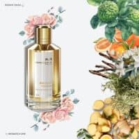 A 120ml bottle of Mancera Instant Crush Eau de Parfum with a gradient gold and clear glass design and a gold cap