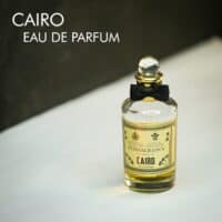 A clear bottle with a black bow tie of Penhaligon's Cairo Eau de Parfum with black font labels.