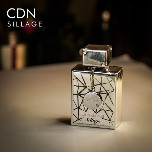 A 105ml bottle of Armaf Club de Nuit Sillage Eau de Parfum with a silver bottle and cap on a white table.