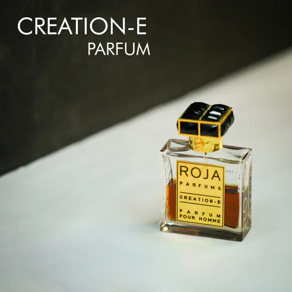 A clear bottle with light brown liquid of Roja Parfums Enigma/Creation-E Parfum with black font labels.
