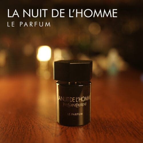 a 100ml bottle of Yves Saint Laurent La Nuit de l’Homme Le Parfum with a dark cylindrical glass design, a matte black cap a brown table.