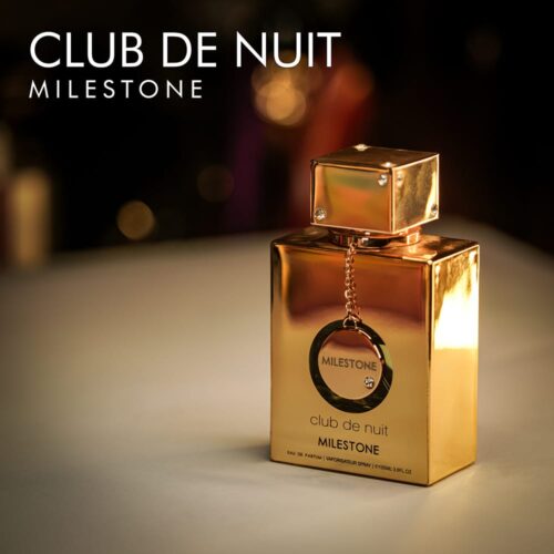 A 105ml bottle of Armaf Club de Nuit Milestone Eau de Parfum with a gold-tone bottle and cap on a brown table.