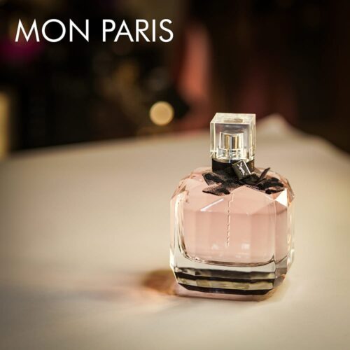 a 90ml bottle of YSL mon paris with black ribbon on a white table