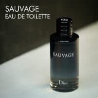 A dark tinted bottle of Dior Sauvage Eau de Toilette with white font labels.