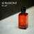 A light red bottle of Giorgio Armani Si Passione Eclat Eau de Parfum with gold font labels.
