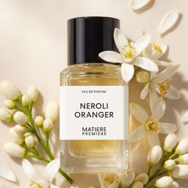 24 Elegant Neroli Oranger perfume bottle surrounded by white floral accents, capturing fresh citrus and floral aroma.