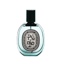 a 100ml bottle of Diptyque Tam Dao Eau de Parfum with a clear glass design, clear liquid, and a black cap on a brown table.
