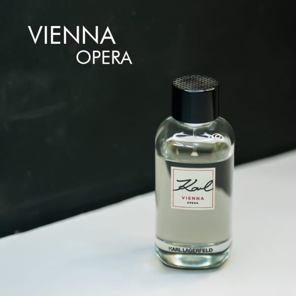 a 100ml bottle of Karl Lagerfeld Vienna Opera Eau de Toilette with a sleek black glass design and black cap on a brown table.