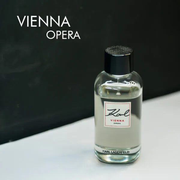 a 100ml bottle of Karl Lagerfeld Vienna Opera Eau de Toilette with a sleek black glass design and black cap on a brown table.