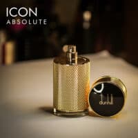 a 100ml bottle of Dunhill Icon Absolute Eau de Parfum with a textured gold design, and a gold cap on a brown table.
