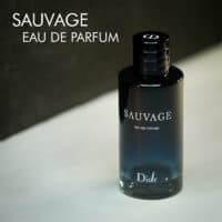 A dark tinted bottle of Dior Sauvage Eau de Parfum with white font labels.