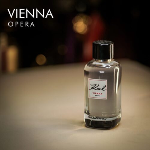 a 100ml bottle of Karl Lagerfeld Vienna Opera Eau de Toilette with a sleek black glass design and black cap on a brown table.