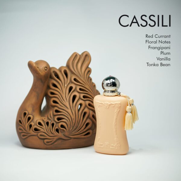 a 75ml bottle of Parfums de Marly Cassili Eau de Parfum with a light orange design on a white table with a clay swan