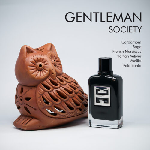 A 100ml bottle of Givenchy Gentleman Society Eau de Parfum, featuring a sleek rectangular black glass design with a metallic silver plate and a black cap, placed on a white table.