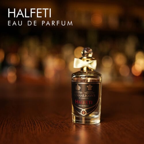 a 100ml bottle of Penhaligon's Halfeti Eau de Parfum with golden design and black label on a brown table