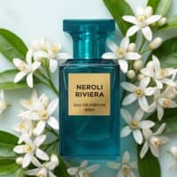34 Fresh Neroli Riviera perfume with floral scent, surrounded by white blossoms and green leaves.