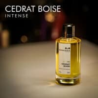a 120ml bottle of Mancera Cedrat Boise Intense Extrait de Parfum with a gold glass design and black cap on a white table