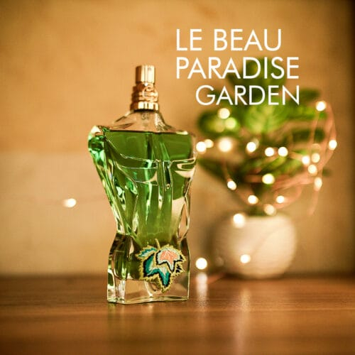 a 75ml bottle of Jean Paul Gaultier Le Beau Paradise Garden Eau de Parfum with a clear glass design and green detailing on a white table