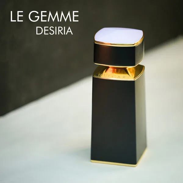 A black bottle with gold and lavender accents of Bvlgari Le Gemme Desiria Eau De Parfum with engraved labels.