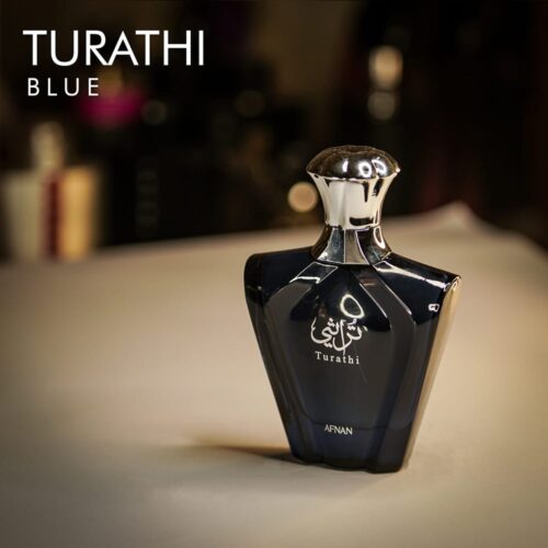 a 90ml bottle of Afnan Turathi Blue Eau de Parfum with a blue textured glass design and silver cap on a white table