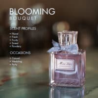 A 100ml bottle of Dior Miss Dior Blooming Bouquet Eau de Toilette with pink liquid and silver cap on a marble table.