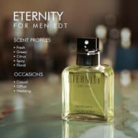 A 100ml bottle of Calvin Klein Eternity For Men Eau de Toilette with clear liquid and black cap on a marble table.