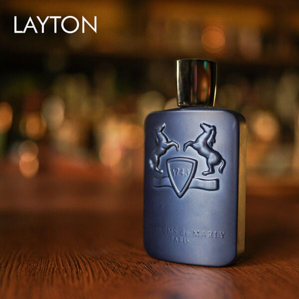 A 125ml bottle of Parfums de Marly Layton Eau de Parfum with a matte midnight blue finish and silver cap on a marble table.