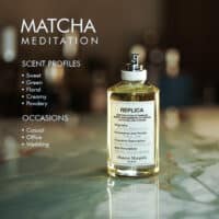 A 100ml bottle of Maison Margiela Matcha Meditation Eau de Toilette with a light green liquid and white label on a marble table