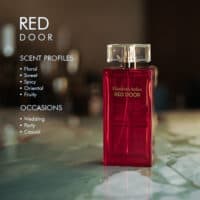 A 100ml bottle of Elizabeth Arden Red Door Eau de Toilette with a red and gold design on a marble table